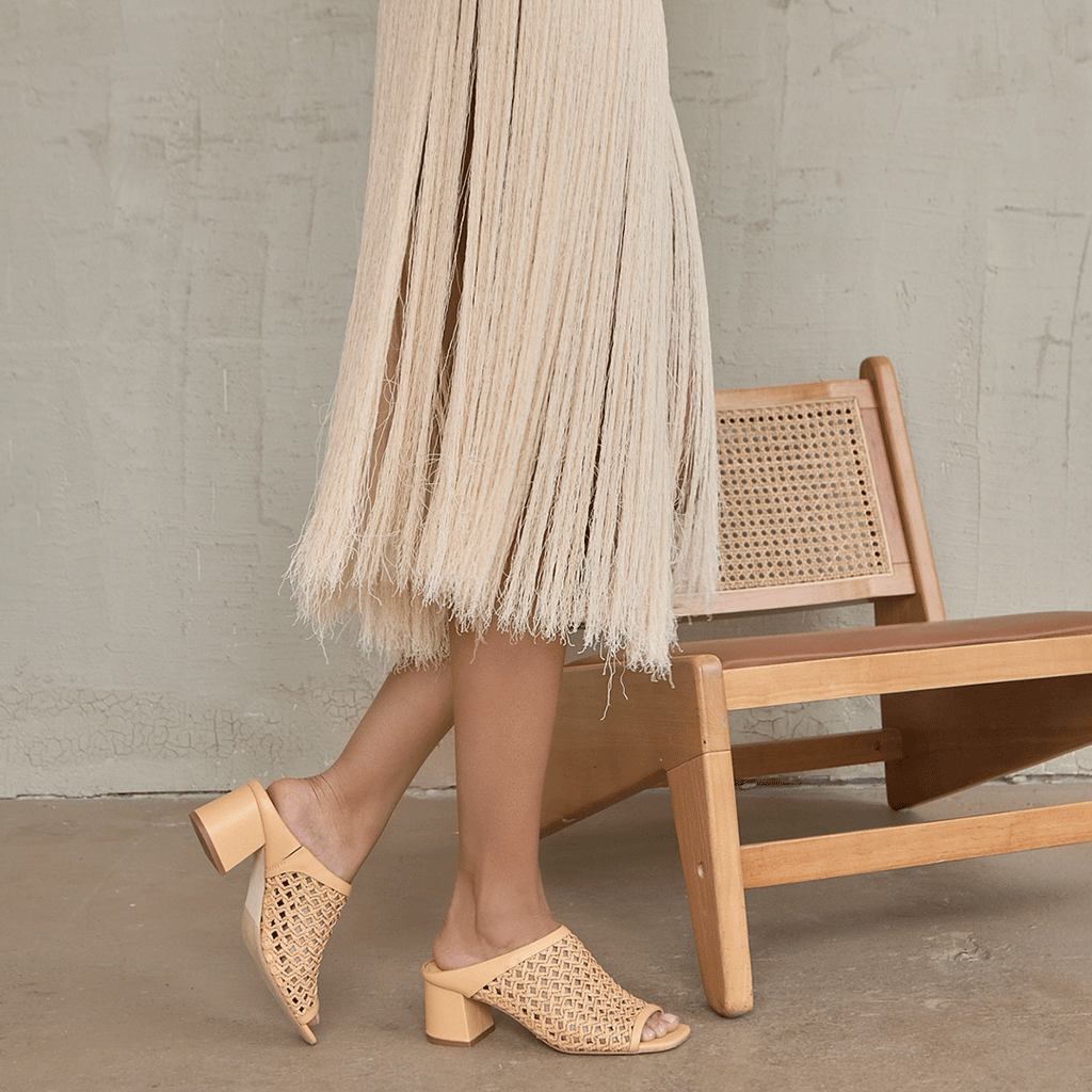 Close-up of Daniella Shevel Sienna Slide sandal in camel, styled with a flowing skirt, capturing movement and effortless elegance.