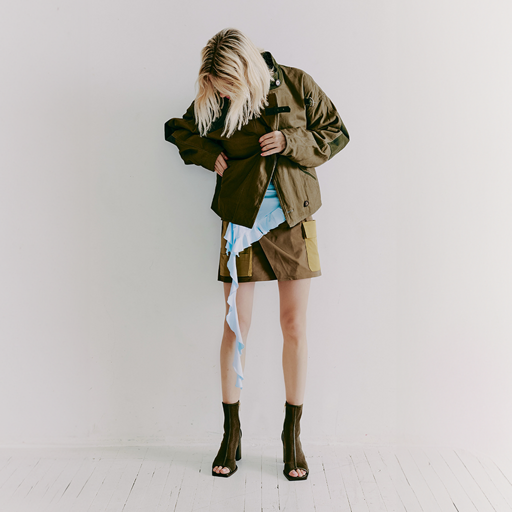 Daniella Shevel Onyx olive ankle boots paired with a textured shirt and army jacker for bold styling.