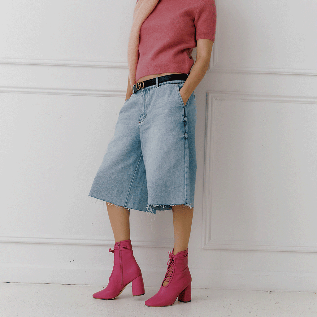 Daniella Shevel Belladonna Lace up boot in intense pink side view in fall styling with scarf and sweater and jeans zipper view