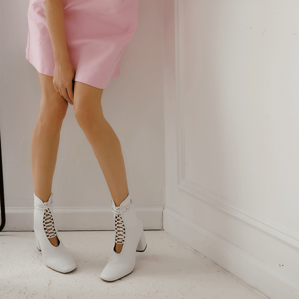 Daniella Shevel Belladonna Lace up boot in white front view in pink mini dress