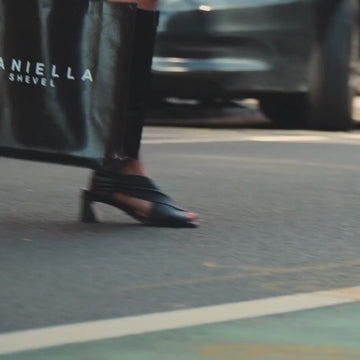 Daniella Shevel Harper Wrap leather heel sandal in black, stone white, and lobster red