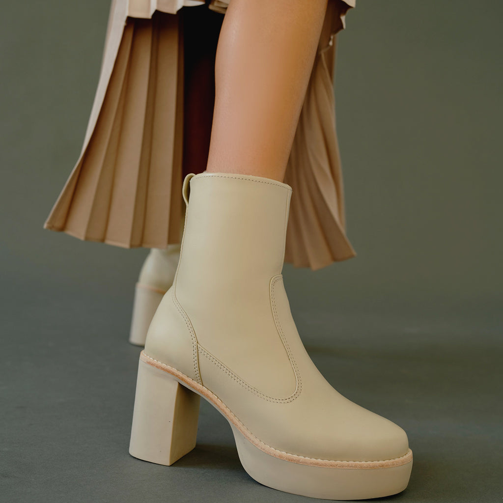 Daniella Shevel Aspen Shearling Boot waterproof and weatherproof with rubber lugg sole with Rokh skirt