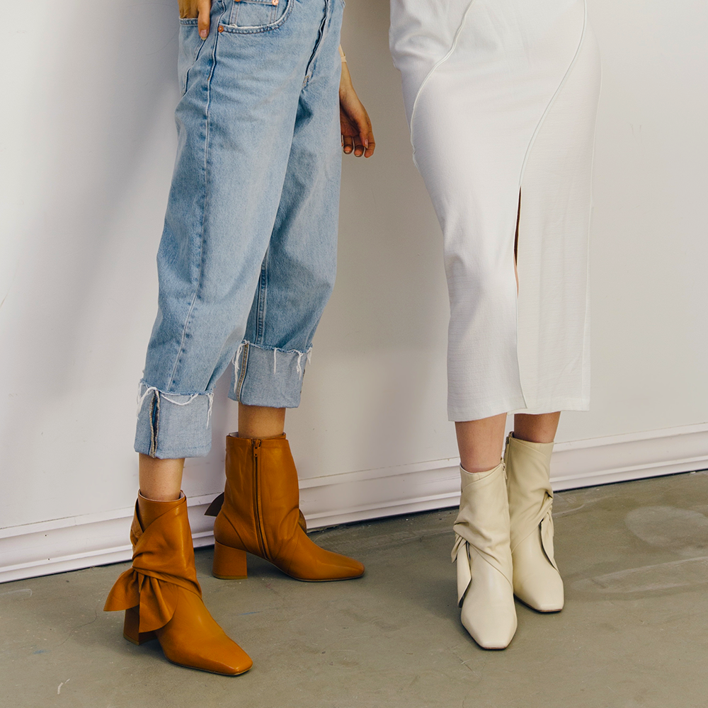 Daniella Shevel Bonnie Bow Tie Bootie in Stone White Cream and brown with denim and white skirt