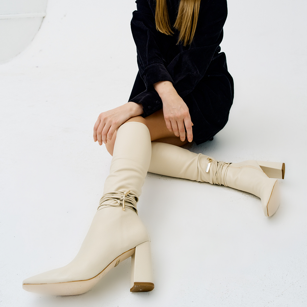 Daniella Shevel Cream Blonde Tall Shaft Boot in Leather stretch side view with black tweed dress