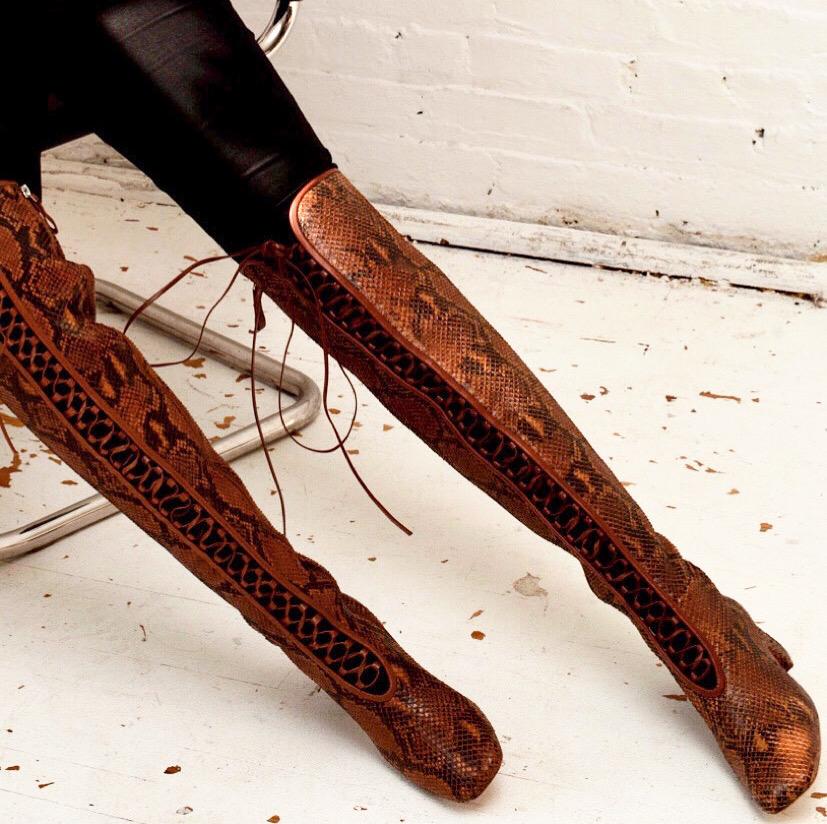 Daniella Shevel Koa Brown Printed Snake Leather Boot with low Heel over the knee on model with black jean pants
